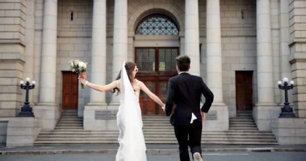 City, walking and back of couple for wedding at town hall for marriage certificate, ceremony and le