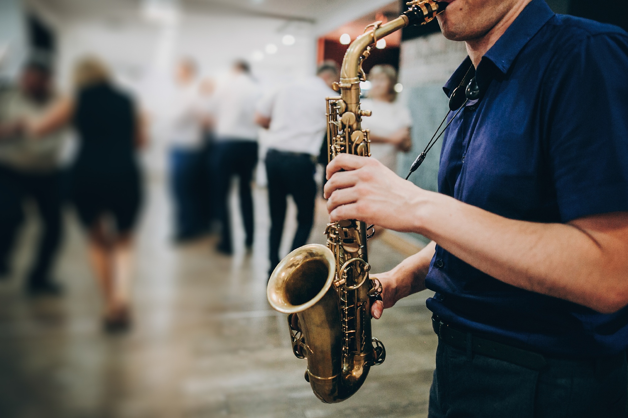 Musician playing sax at wedding reception in restaurant