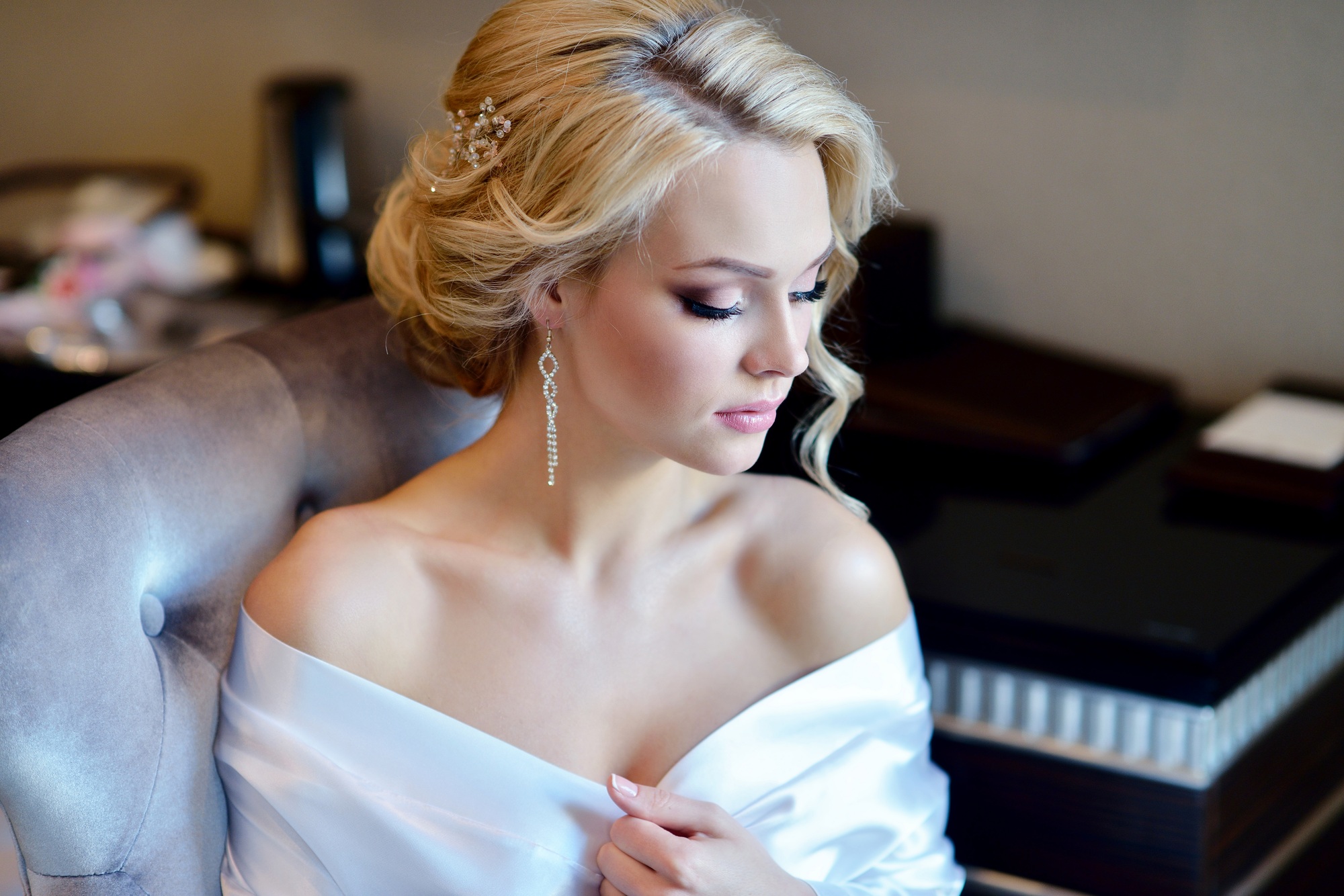 Beauty bride in dressing gown with bridal makeup indoors