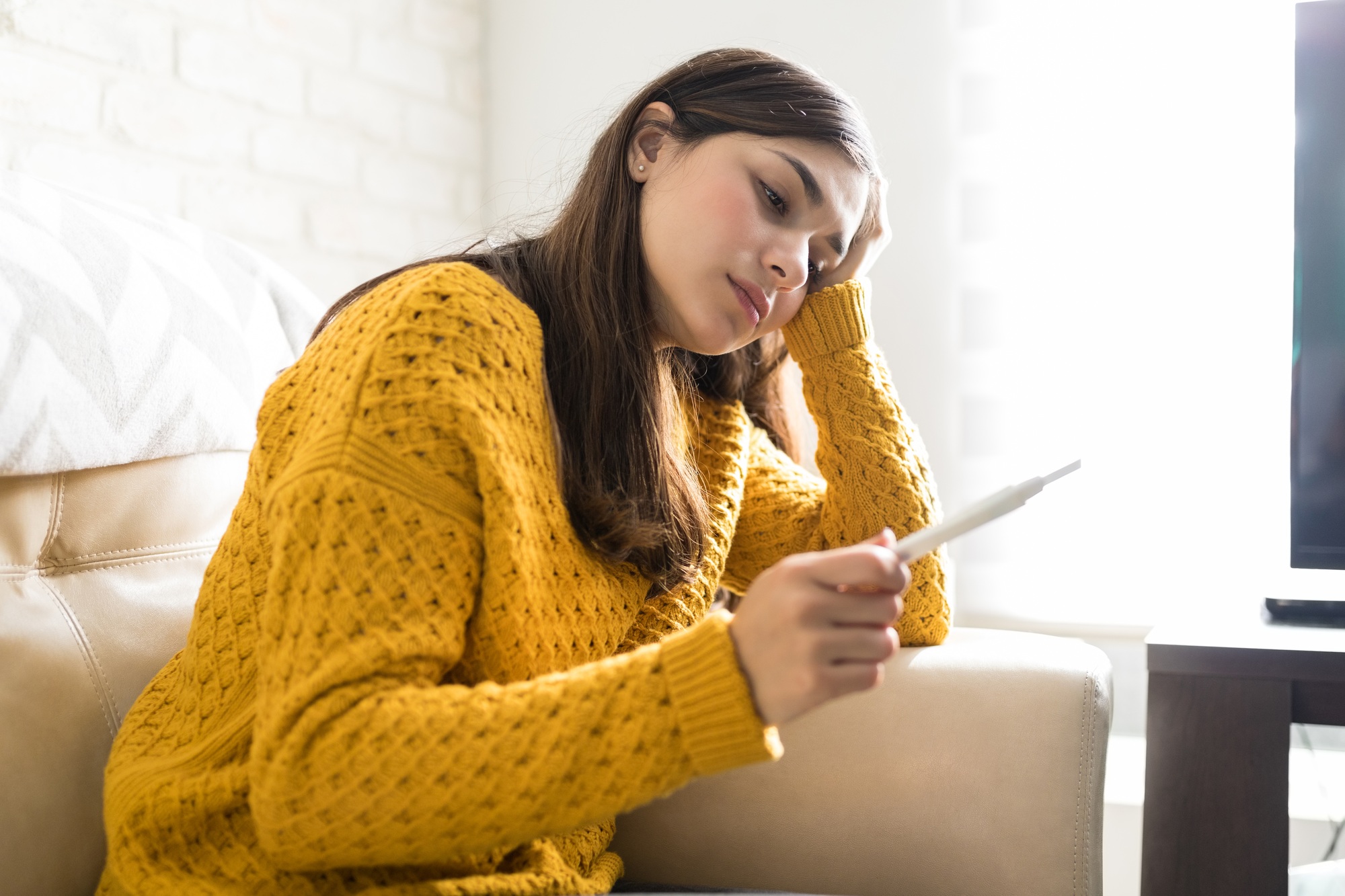 Worried Woman Holding Pregnancy Kit